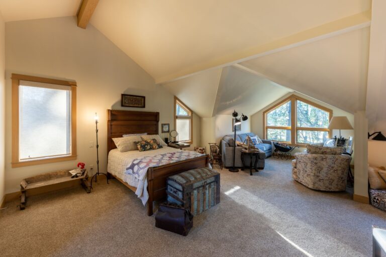 Elegant primary suite with soaring ceilings and a serene sitting area crafted for comfort and style