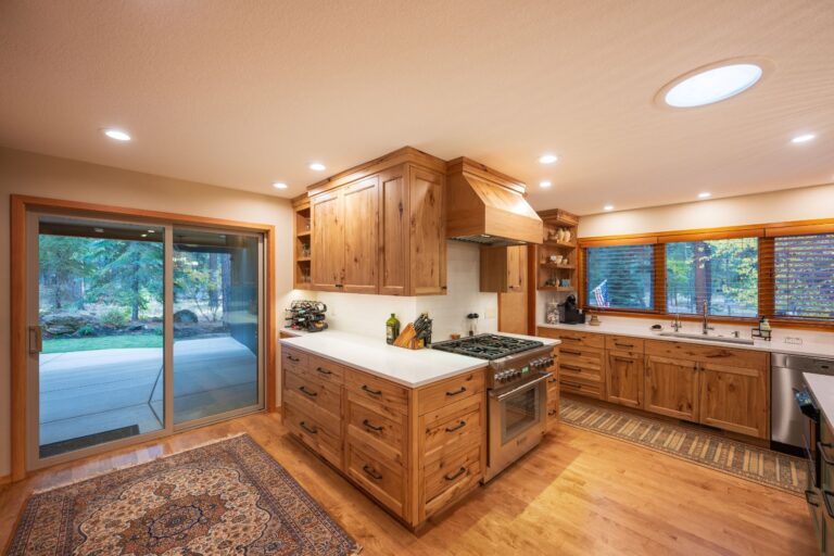 A cozy kitchen design with handcrafted wood cabinets, modern appliances, and abundant natural light blending rustic charm with contemporary function.