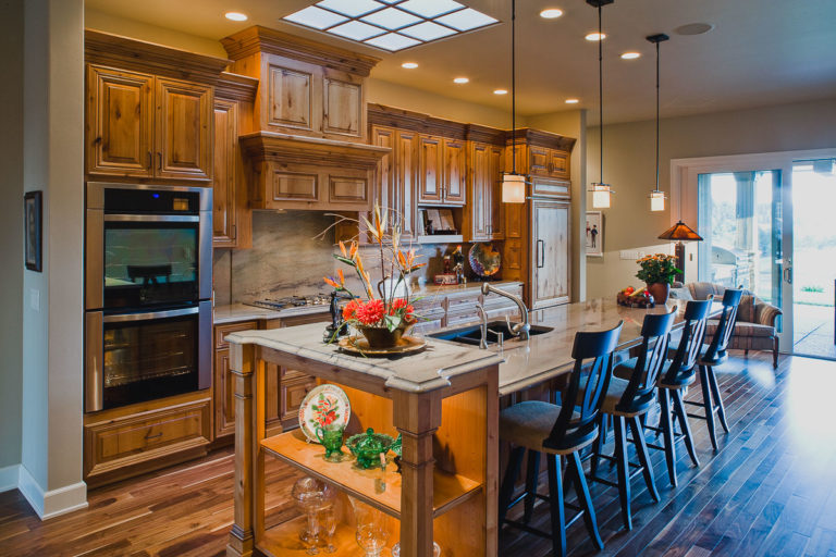 Kitchen, Cabinets, granite counter, appliances, skylight grid, walnut hardwood floor, pendant light, accent light
