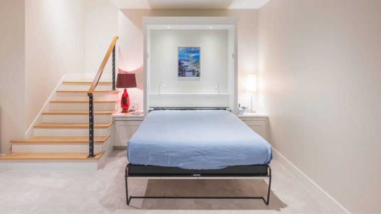 A versatile bedroom design featuring a Murphy bed, built-in storage, and a sleek staircase with cable railing.